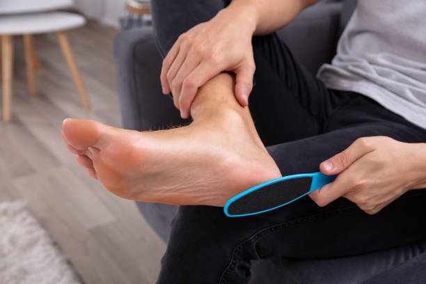 Close up of a man's hand filling foot with foot file